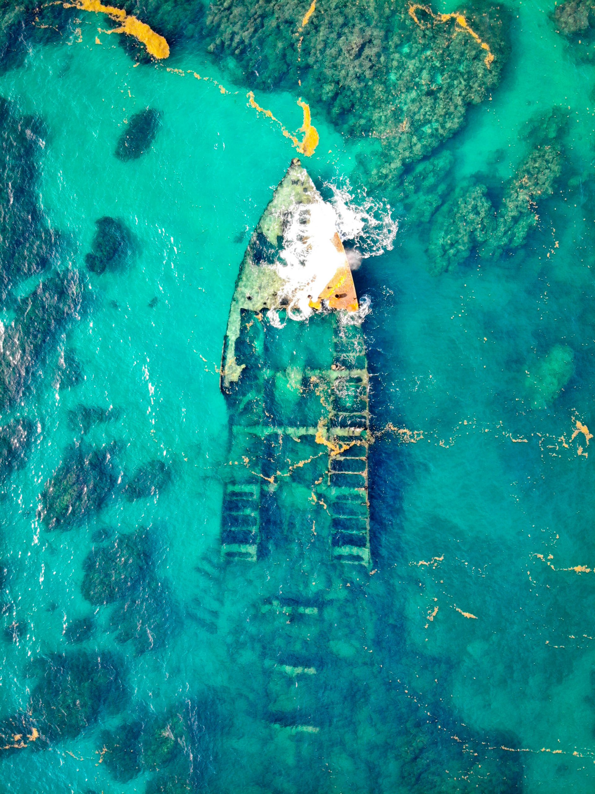 aerial-view-of-a-ship-wreck-on-body-of-water-3675390